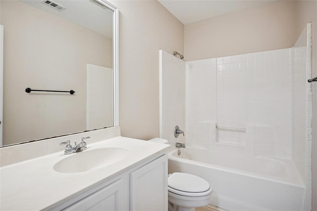 407 Autry Boulevard Gunter, TX 75058 - Photo 22 of 28 a bathroom with a sink a toilet and shower