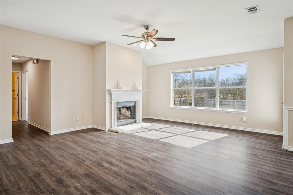 407 Autry Boulevard Gunter, TX 75058 - Photo 5 of 28 a view of an empty room with wooden floor and a window