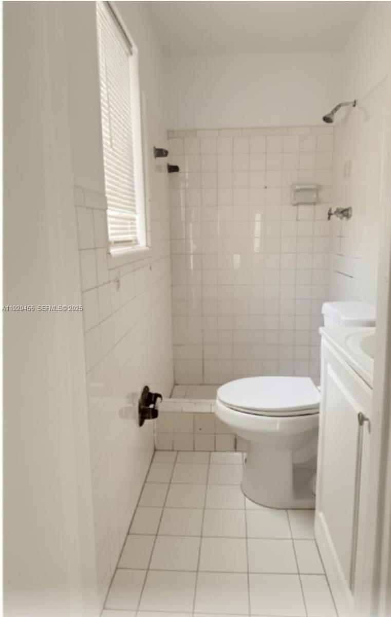 1820 Funston Street, Unit A Hollywood, FL 33020 - Photo 5 of 6 a white toilet sitting next to a bathroom sink