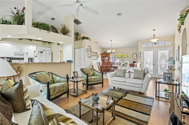 a living room with lots of furniture and a chandelier