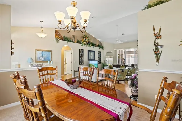 a living room with dining table and chairs