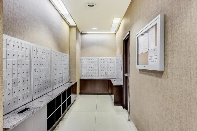 a view of an empty room with wooden floor and windows