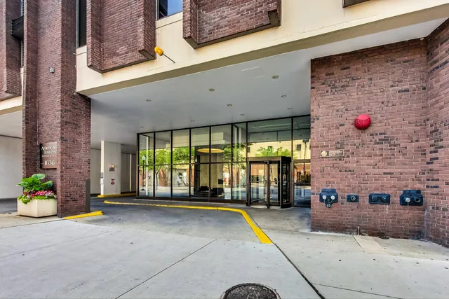 a front view of a building with a garden