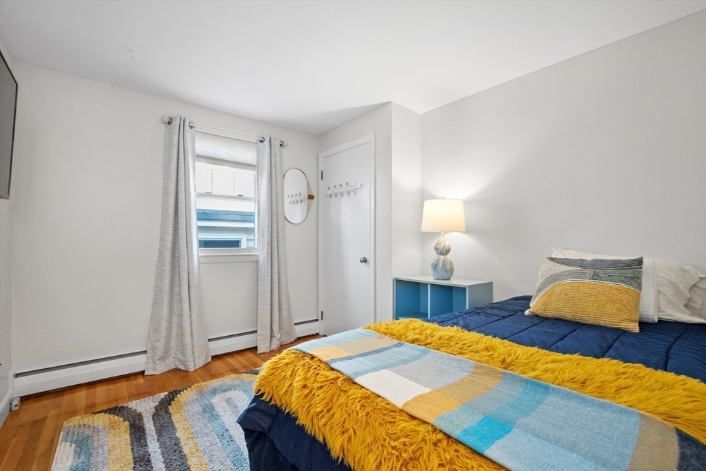 2 Lodge Road Natick, MA 01760 - Photo 19 of 36 a bedroom with a bed and wooden floor