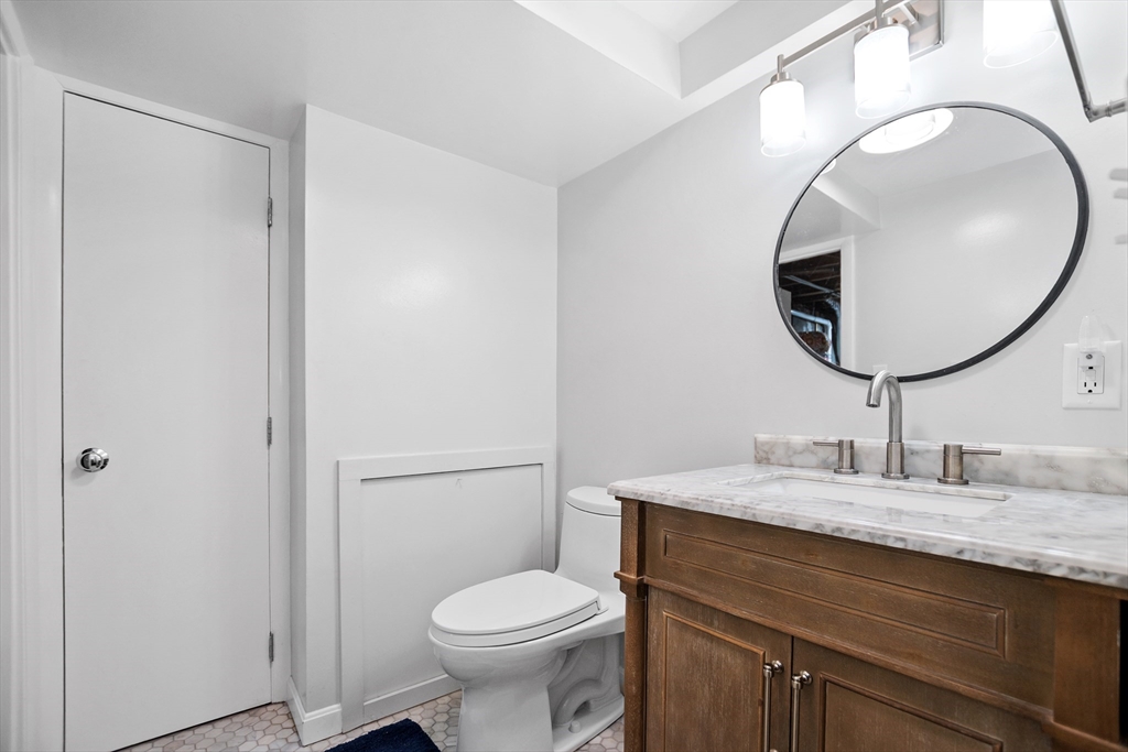 2 Lodge Road Natick, MA 01760 - Photo 21 of 36 a bathroom with a granite countertop sink mirror and toilet