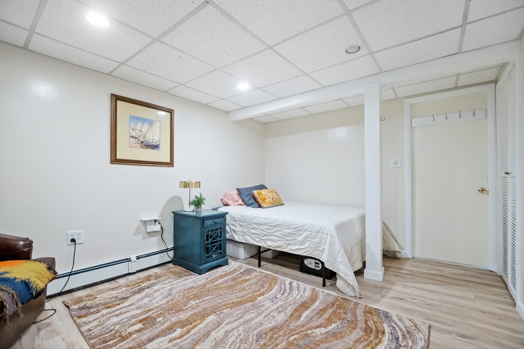 2 Lodge Road Natick, MA 01760 - Photo 23 of 36 a bedroom with a bed and wooden floor