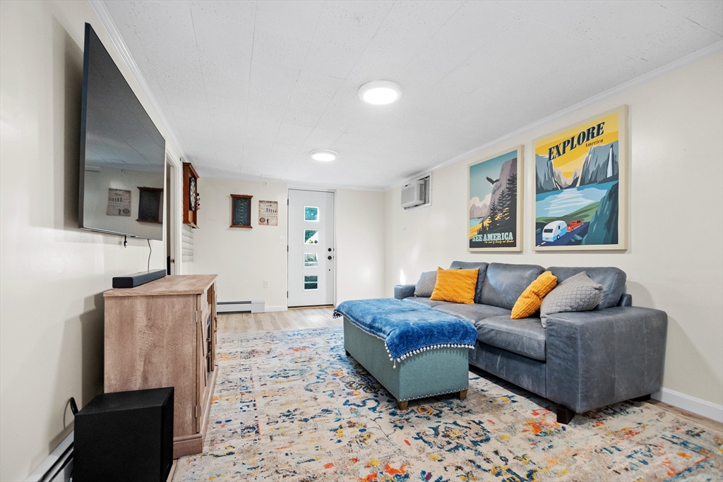2 Lodge Road Natick, MA 01760 - Photo 26 of 36 a living room with furniture and a flat screen tv