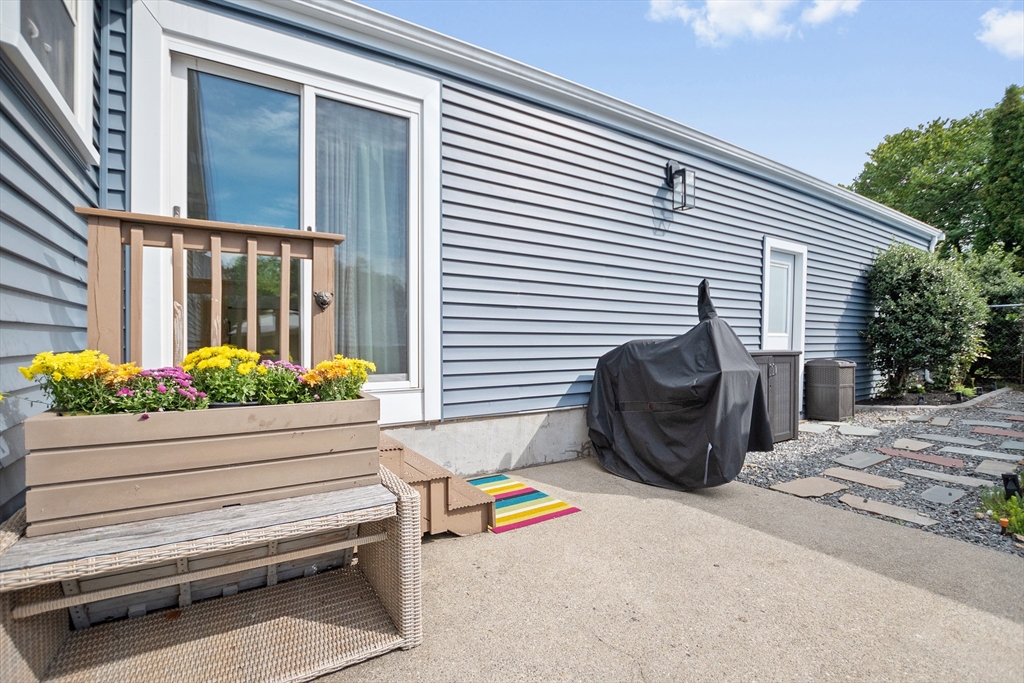 2 Lodge Road Natick, MA 01760 - Photo 31 of 36 a view of a chair and tables back yard of the house
