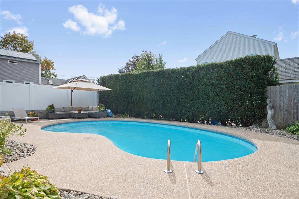 2 Lodge Road Natick, MA 01760 - Photo 33 of 36 a view of a swimming pool with a yard and plants