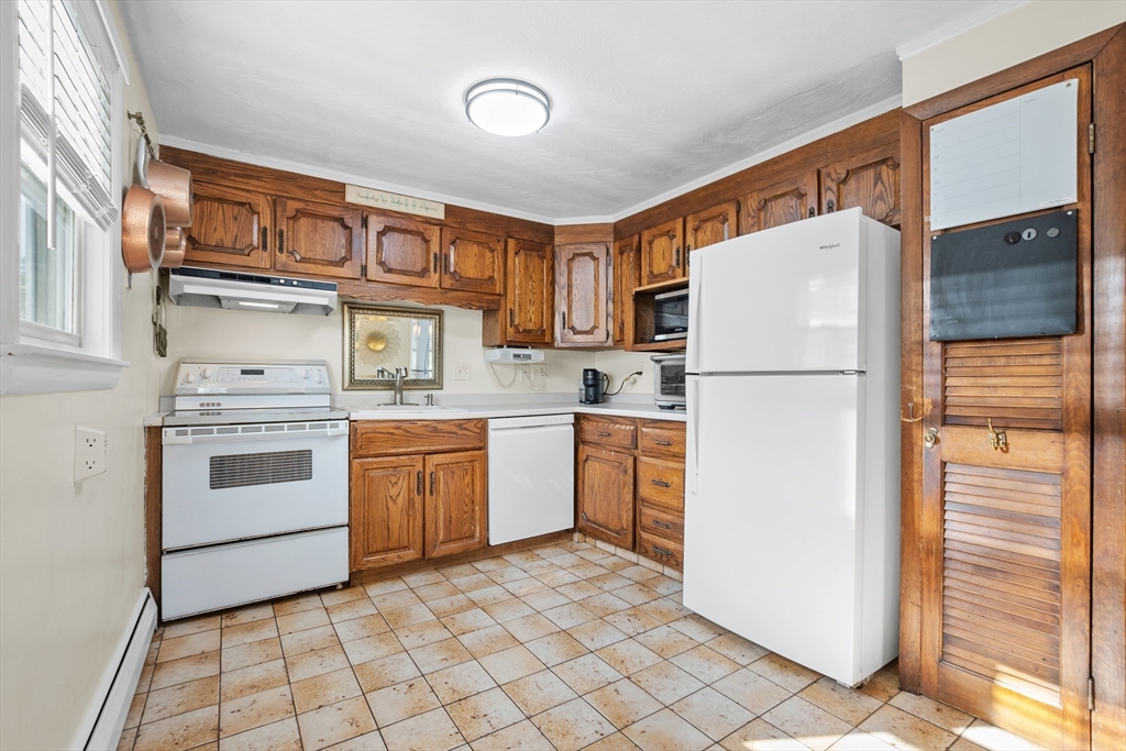 2 Lodge Road Natick, MA 01760 - Photo 7 of 36 a kitchen with a refrigerator a stove top oven and cabinets