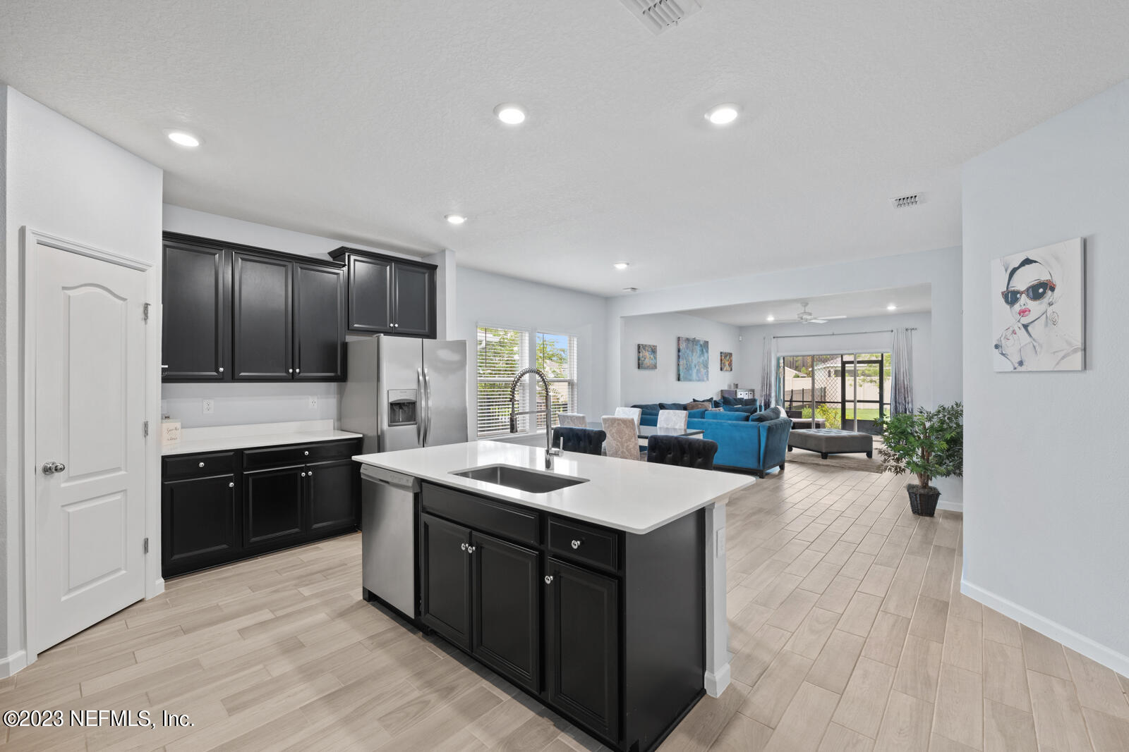31 Seamount Way St. Augustine, FL 32092 - Photo 13 of 72 a open kitchen with stainless steel appliances granite countertop a refrigerator a sink dishwasher a stove and a refrigerator with wooden floor