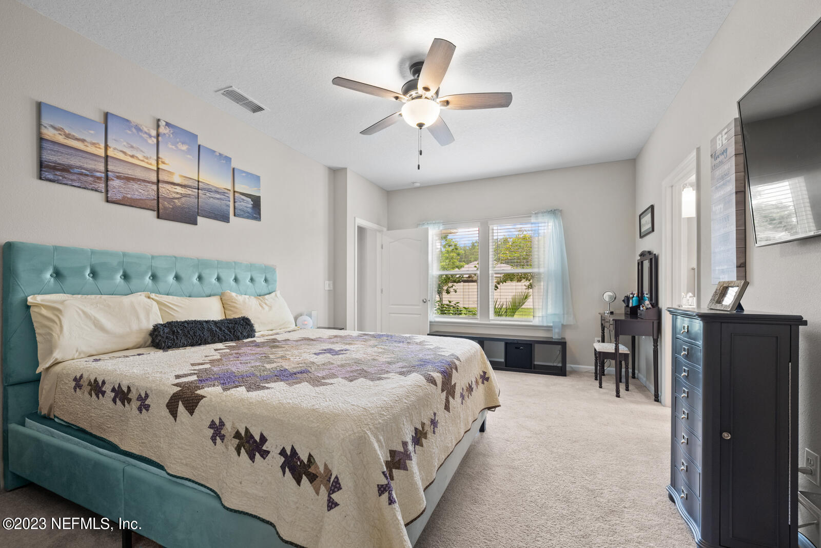 31 Seamount Way St. Augustine, FL 32092 - Photo 22 of 72 a bedroom with a large bed and a chandelier