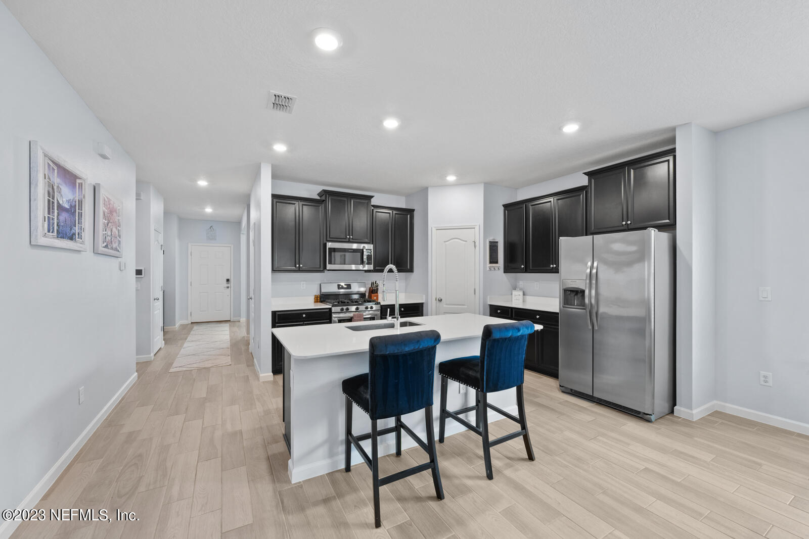 31 Seamount Way St. Augustine, FL 32092 - Photo 8 of 72 a kitchen with stainless steel appliances kitchen island granite countertop a refrigerator and a stove top oven