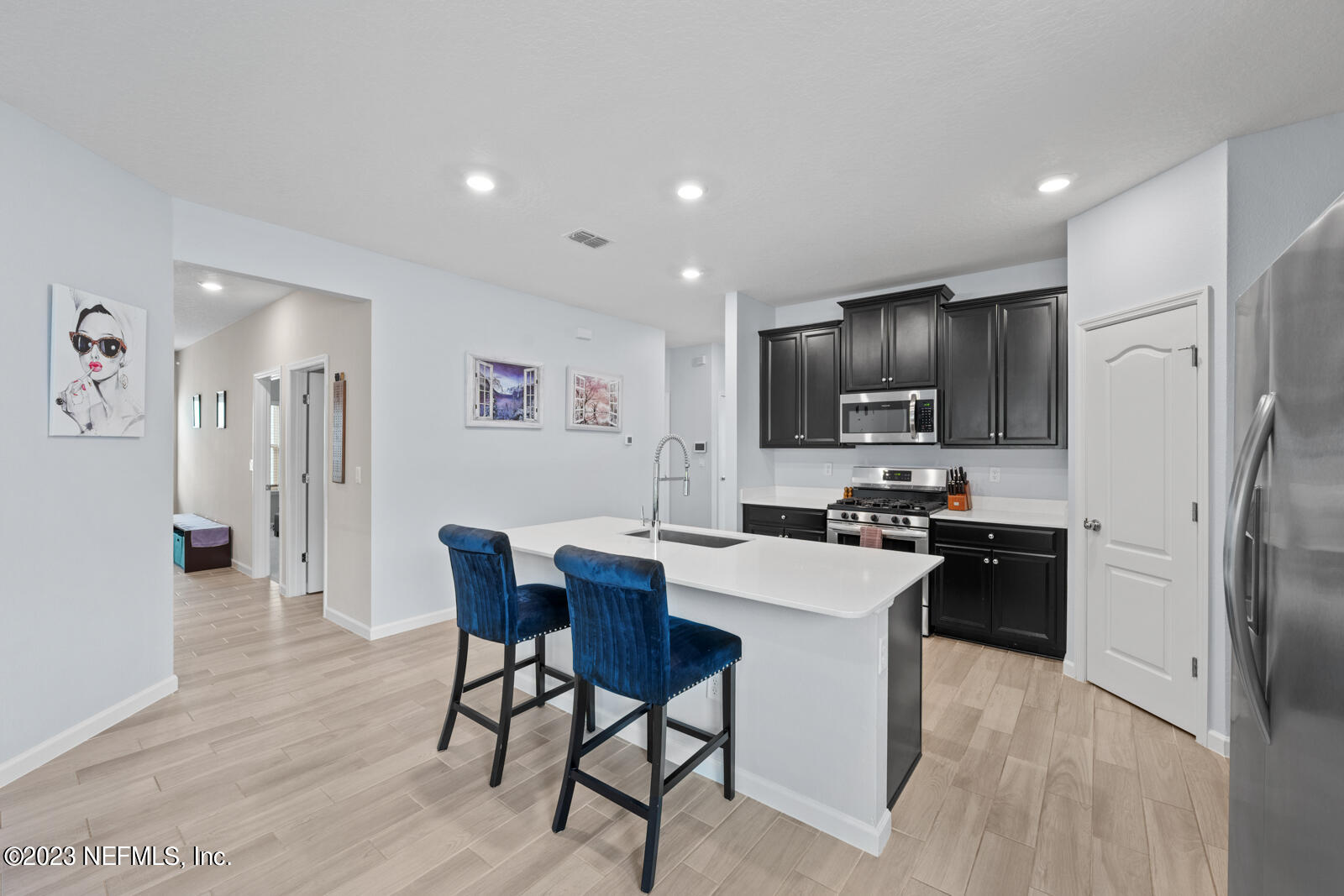 31 Seamount Way St. Augustine, FL 32092 - Photo 9 of 72 a kitchen with a refrigerator a stove top oven a sink dishwasher and wooden floor
