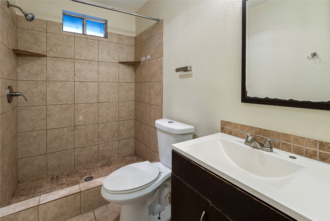 1408 Waterloo Trail, Unit A Austin, TX 78704 - Photo 8 of 13 Full bath with vanity, a stall shower, and a textured wall
