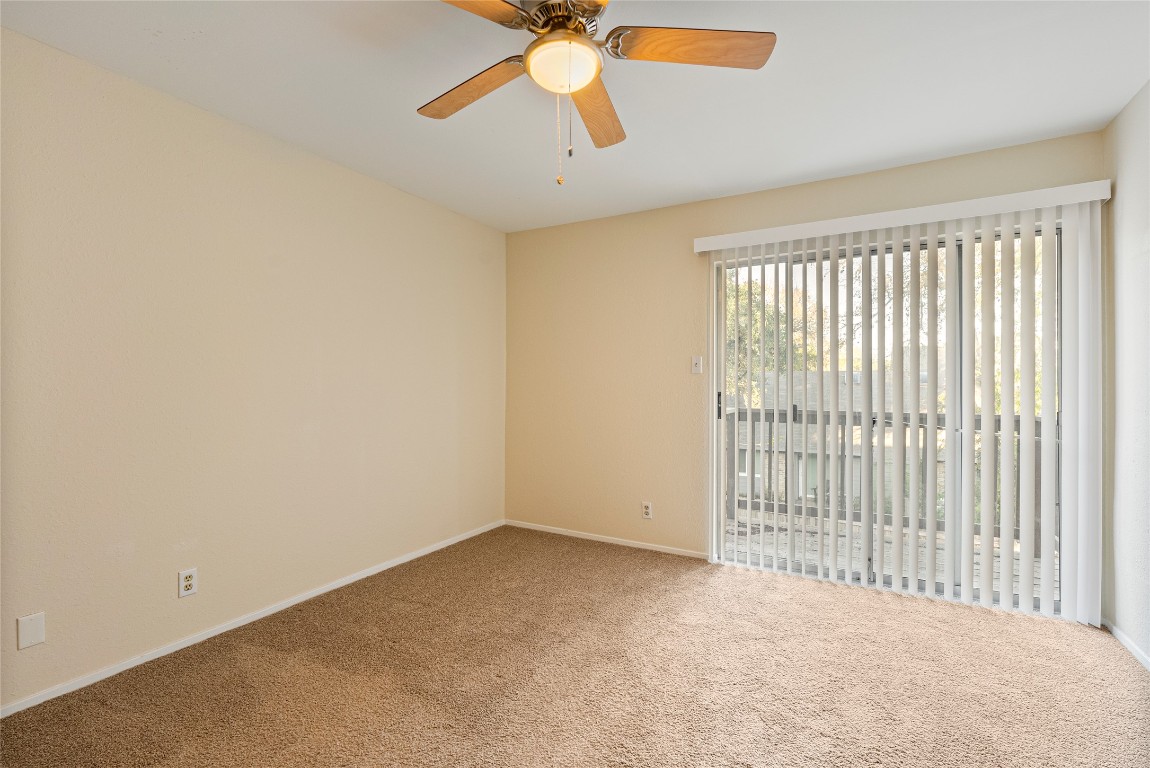 1408 Waterloo Trail, Unit A Austin, TX 78704 - Photo 9 of 13 Carpeted spare room with baseboards and a ceiling fan