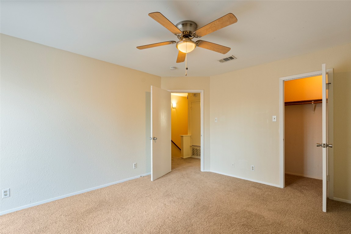 1408 Waterloo Trail, Unit A Austin, TX 78704 - Photo 10 of 13 Unfurnished bedroom featuring carpet, a spacious closet, and ceiling fan