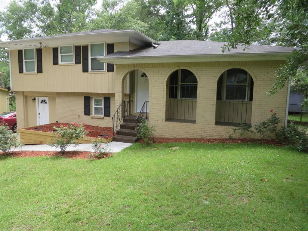 3000 Creel Road Atlanta, GA 30349 - Photo 15 of 52 a front view of a house with garden
