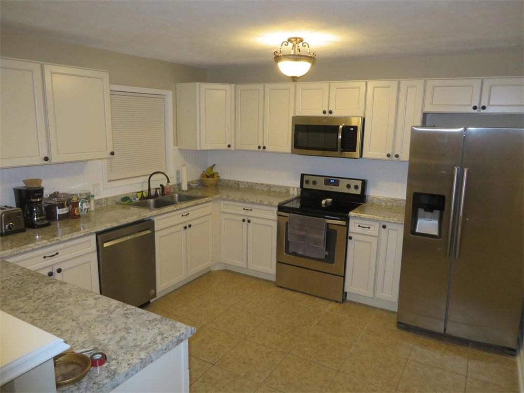 3000 Creel Road Atlanta, GA 30349 - Photo 16 of 52 a kitchen with a sink white cabinets and stainless steel appliances