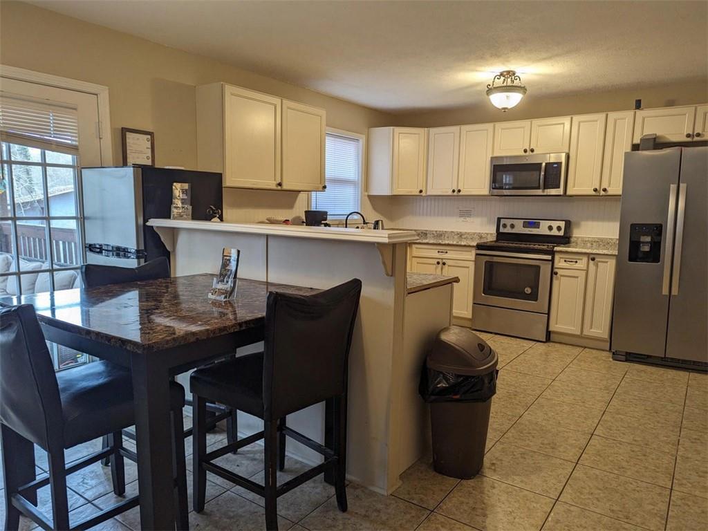 3000 Creel Road Atlanta, GA 30349 - Photo 17 of 52 a kitchen with a refrigerator and a stove top oven