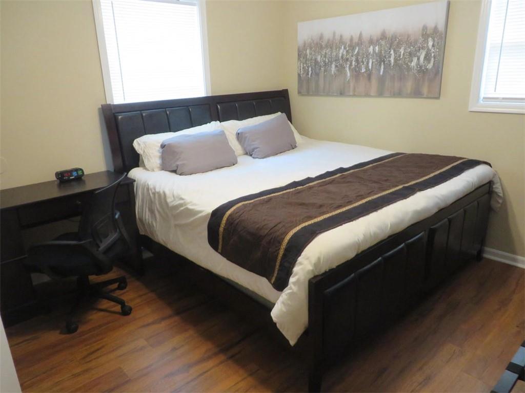 3000 Creel Road Atlanta, GA 30349 - Photo 18 of 52 a bedroom with a bed and wooden floor