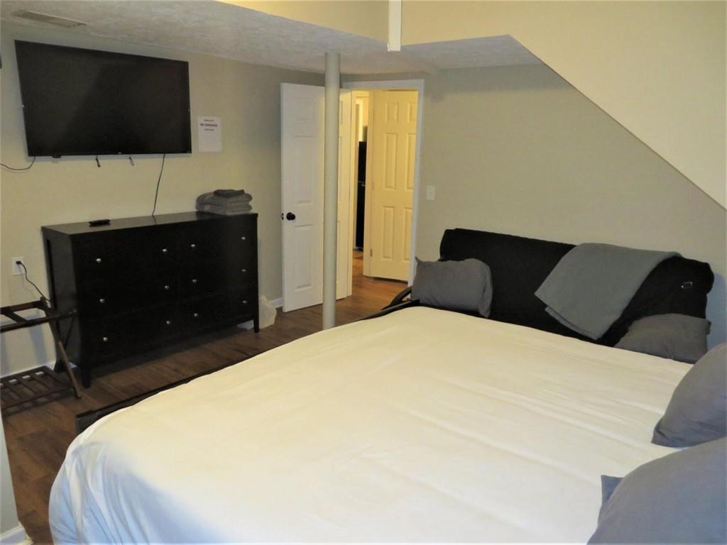 3000 Creel Road Atlanta, GA 30349 - Photo 20 of 52 a bedroom with a bed and a flat screen tv
