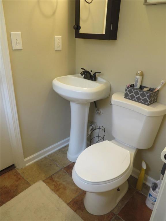 3000 Creel Road Atlanta, GA 30349 - Photo 21 of 52 a bathroom with a toilet sink and mirror