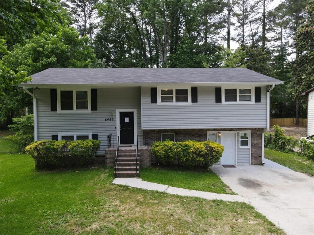 3000 Creel Road Atlanta, GA 30349 - Photo 26 of 52 a front view of a house with garden