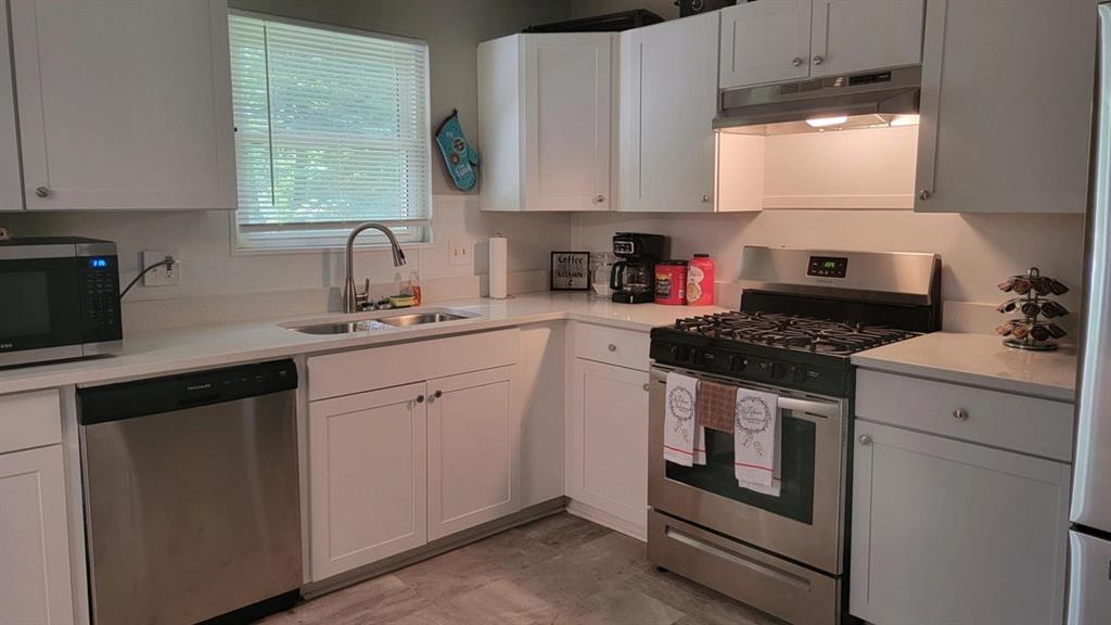 3000 Creel Road Atlanta, GA 30349 - Photo 27 of 52 a kitchen with cabinets appliances a sink and a window