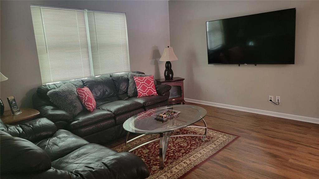 3000 Creel Road Atlanta, GA 30349 - Photo 31 of 52 a living room with furniture and a flat screen tv