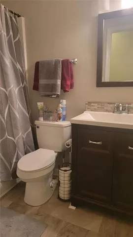 a balcony with wooden floor and outdoor seating