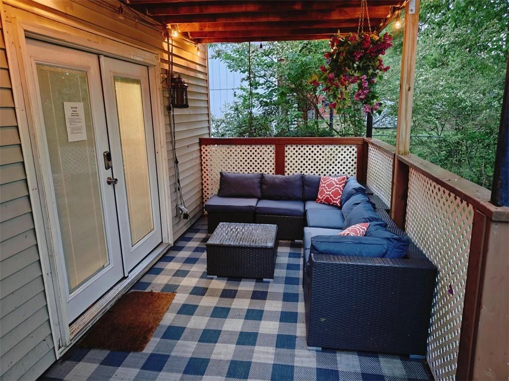 3000 Creel Road Atlanta, GA 30349 - Photo 38 of 52 a balcony with wooden floor and outdoor seating
