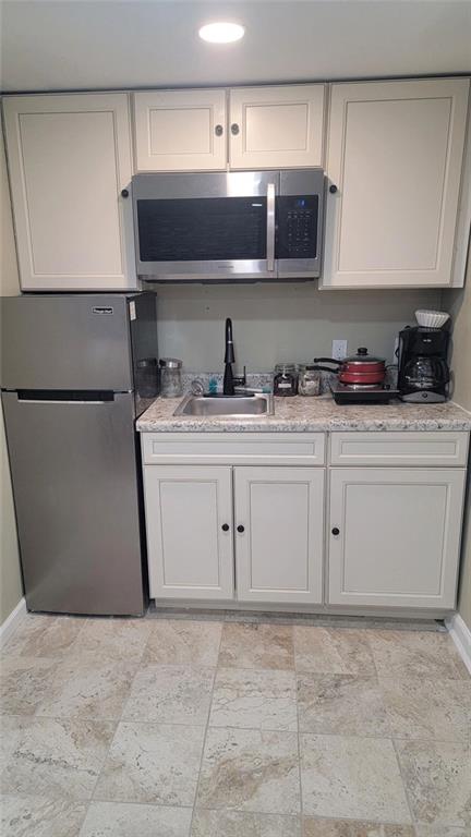 3000 Creel Road Atlanta, GA 30349 - Photo 44 of 52 a kitchen with stainless steel appliances a stove a sink and white cabinets