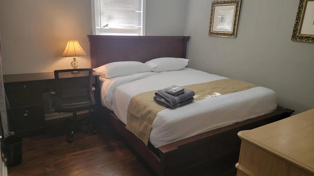 3000 Creel Road Atlanta, GA 30349 - Photo 46 of 52 a bedroom with a bed and a lamp