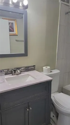 a view of backyard with table and chairs under an umbrella