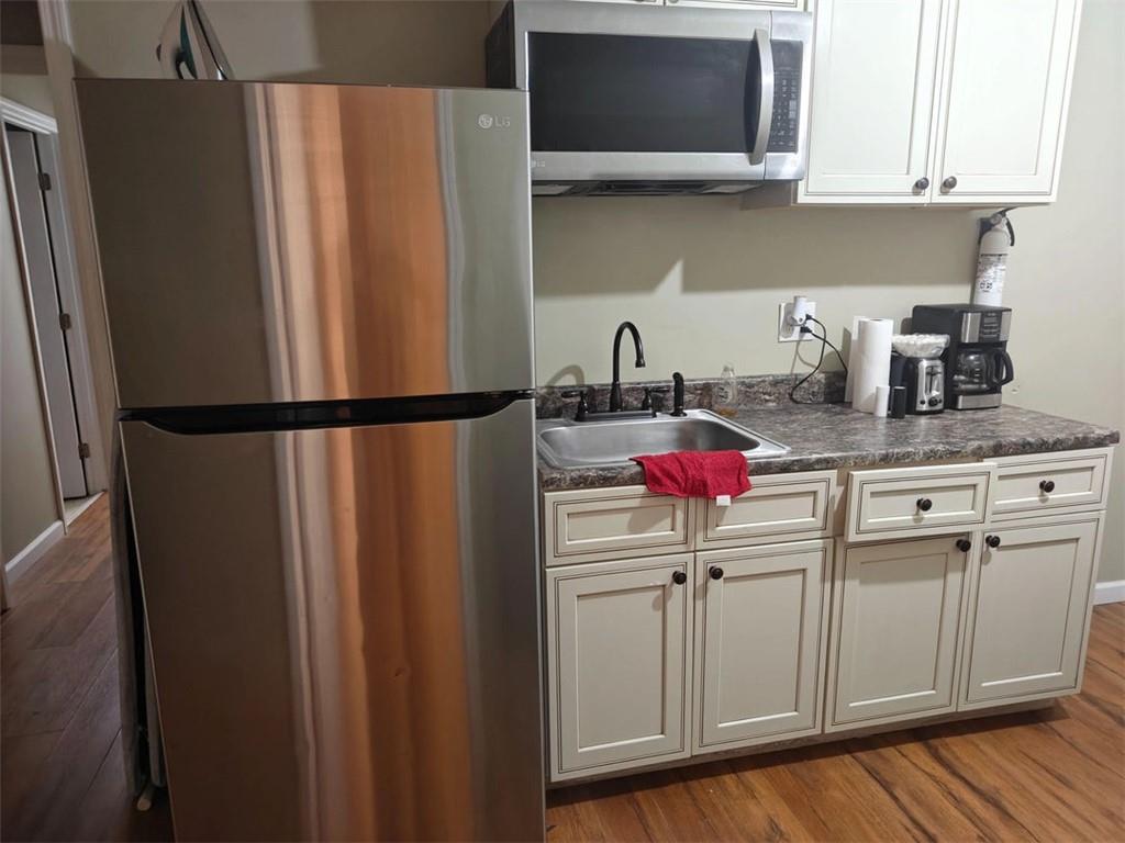 3000 Creel Road Atlanta, GA 30349 - Photo 5 of 52 a kitchen with stainless steel appliances granite countertop a refrigerator sink and cabinets