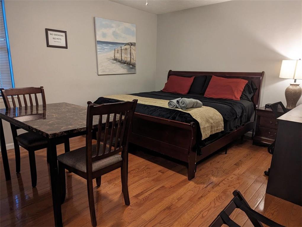 3000 Creel Road Atlanta, GA 30349 - Photo 7 of 52 a bedroom with a bed and wooden floor