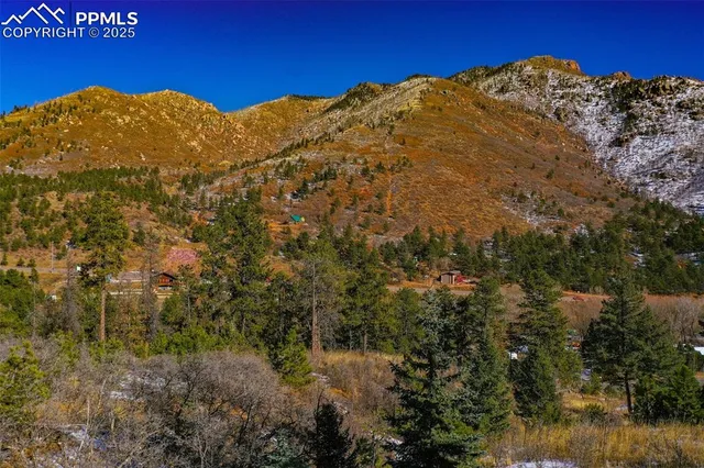 a view of a large mountain with mountains in the background