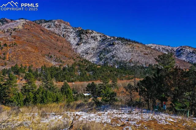 a view of a large building with mountains in the background