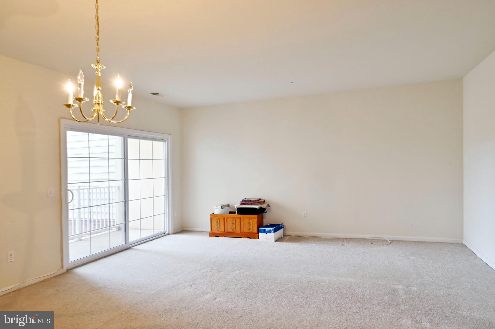 1315 Colts Circle, Unit G Trenton, NJ 08648 - Photo 2 of 12 a room with chandelier and a window