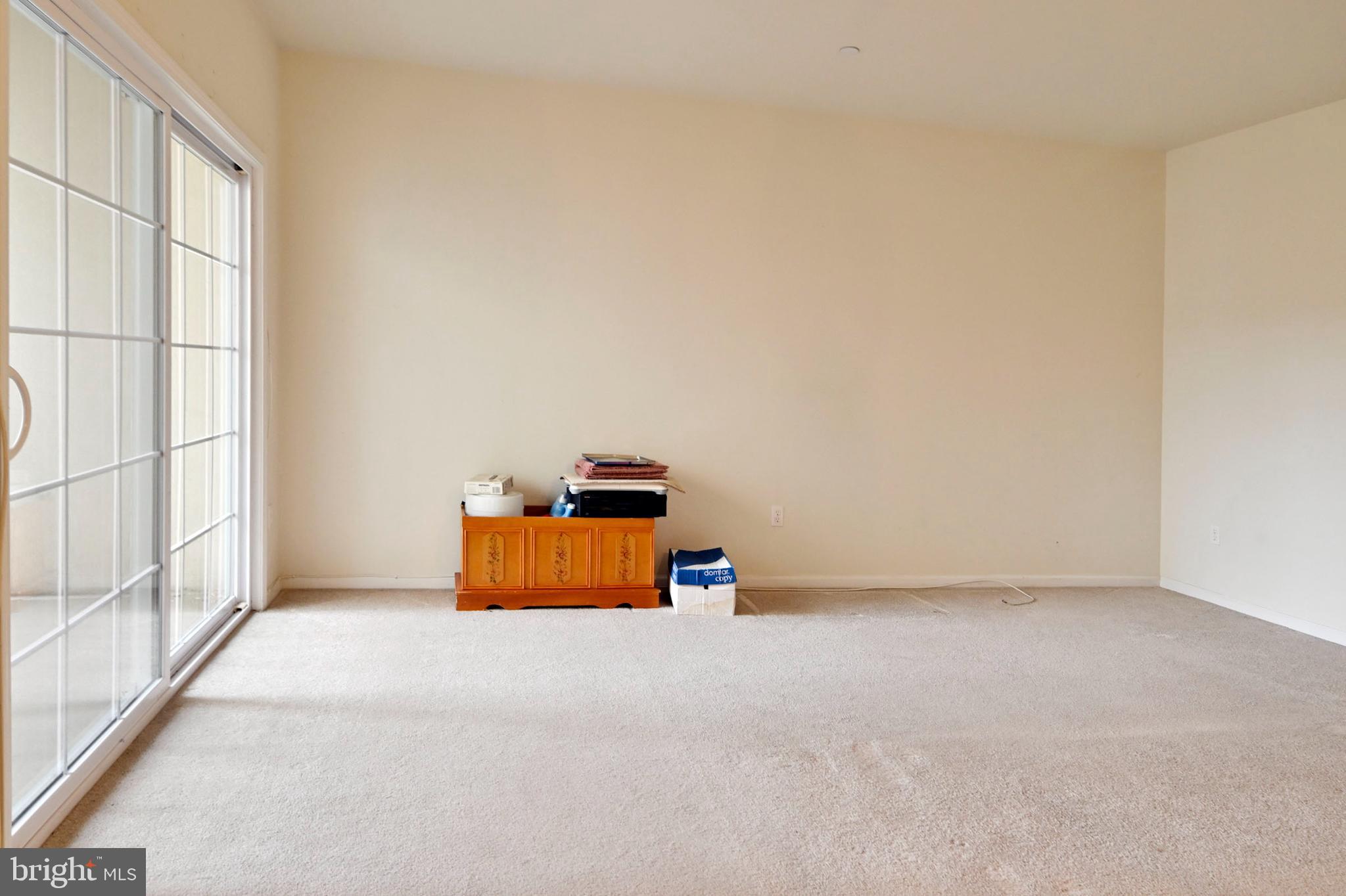 1315 Colts Circle, Unit G Trenton, NJ 08648 - Photo 9 of 12 an empty room with wooden floor and windows