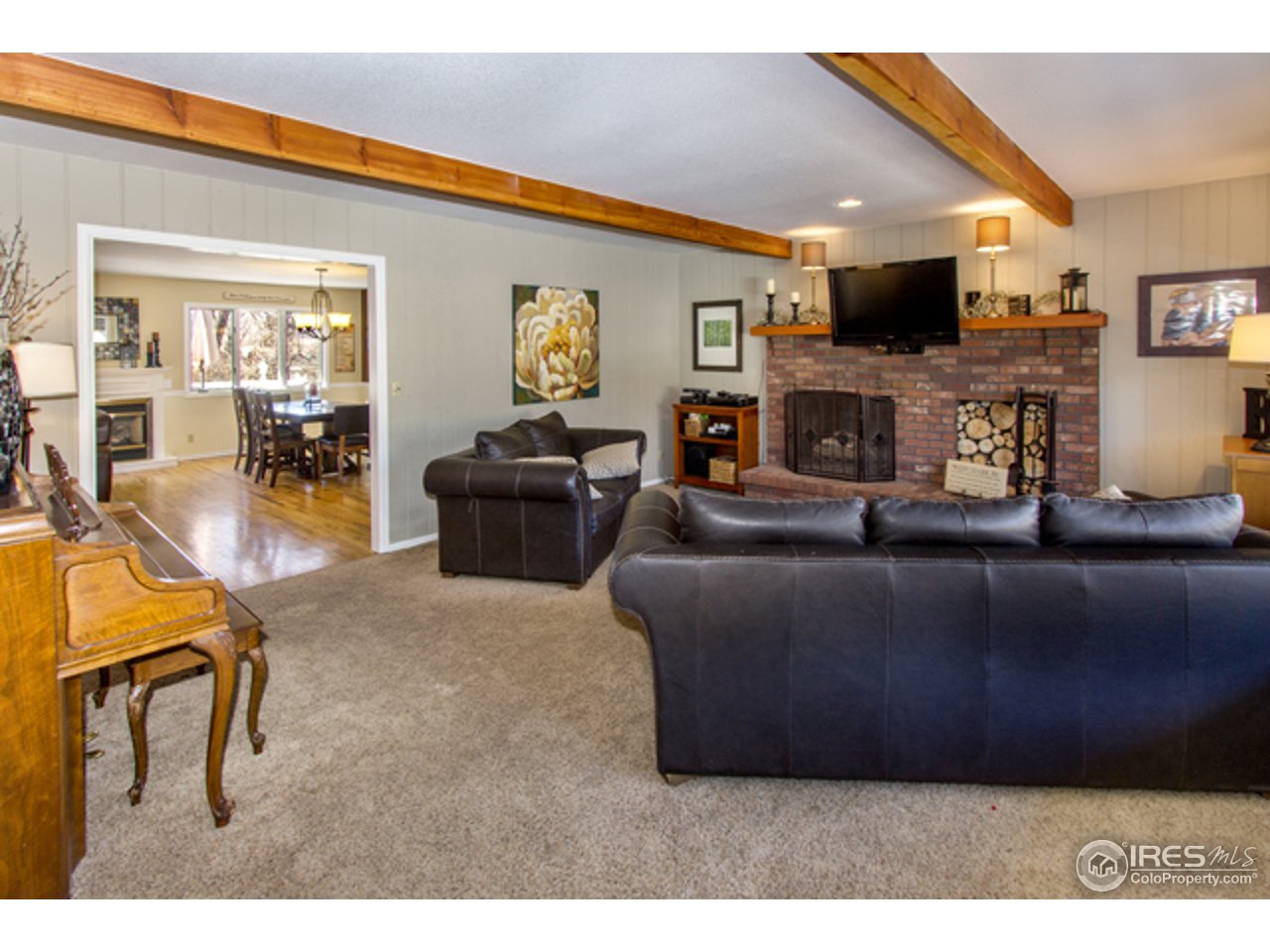 1105 Lin Mar Drive Fort Collins, CO 80521 - Photo 5 of 29 a living room with furniture and a flat screen tv