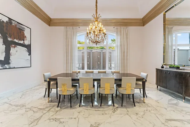a view of a kitchen with kitchen island a refrigerator and a chandelier