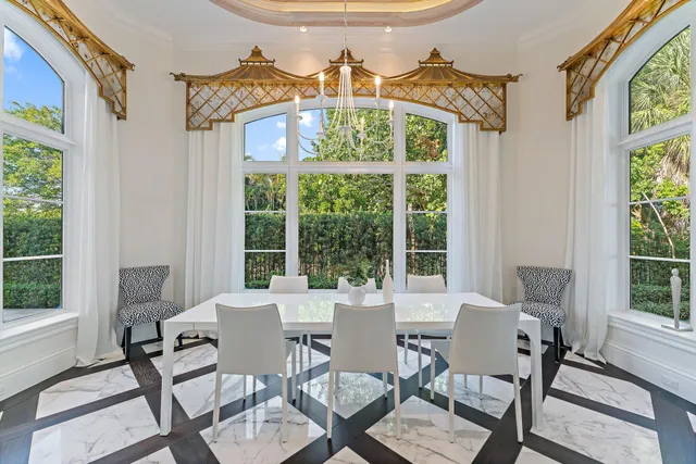 a spacious bedroom with a large bed and a chandelier