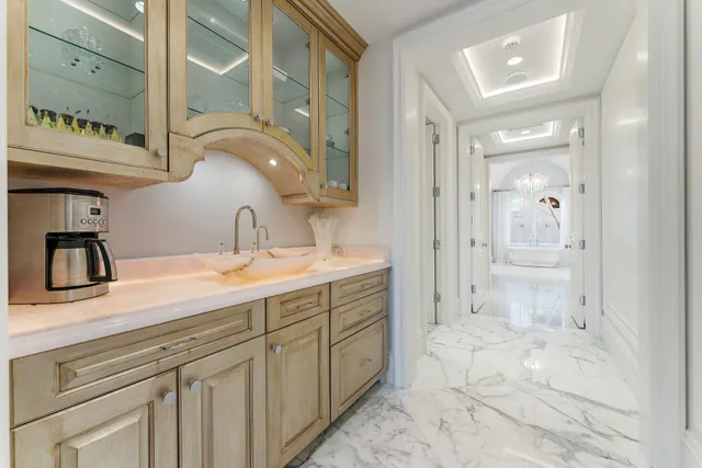 a en suite bathroom with a granite countertop sink and a mirror