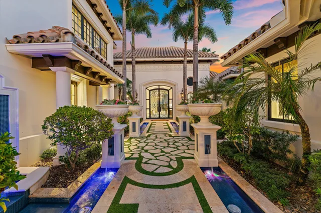 a swimming pool with outdoor seating and a potted plant