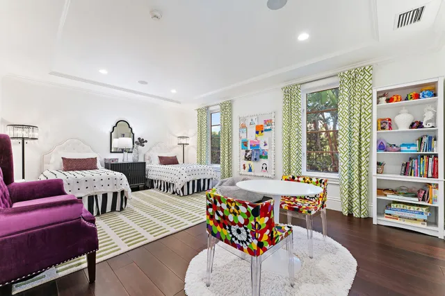 a living room with furniture a large window and wooden floor