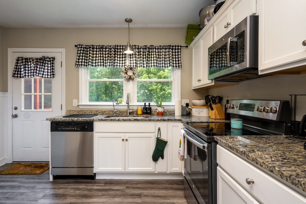 122 South Road Pepperell, MA 01463 - Photo 8 of 24 a kitchen with stainless steel appliances granite countertop a stove a sink and a microwave