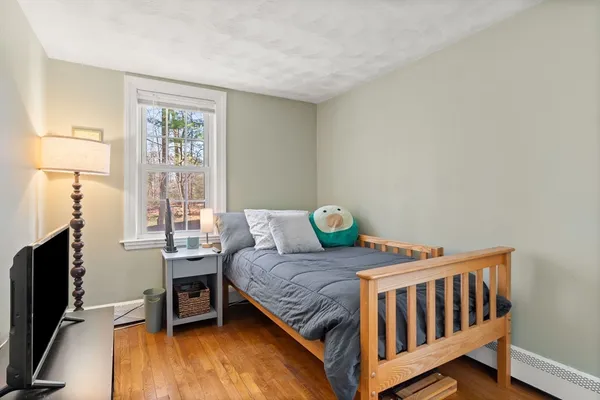 a bedroom with a bed and a tv