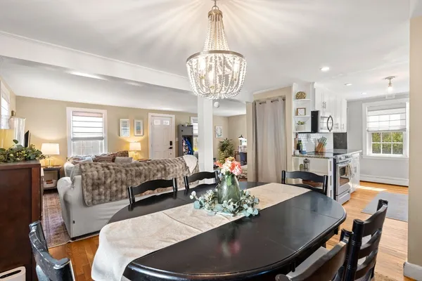 a living room with furniture and a chandelier